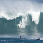 FILE - In this Dec. 8, 2009, file photo, Mark Healey of Hawaii, takes a spill down the face of a large wave in the second heat of The Quiksilver in Memory of Eddie Aikau surf contest at Waimea Bay located on the north shore of the island of Oahu in Hawaii. The Eddie is a go. Organizers of the rarely-held and invitation-only Eddie Aikau  big-wave surfing competition in Hawaii say the event will be held Thursday, Feb. 25, 2016. The competition in memory of legendary big wave surfer Eddie Aikau hasn't been held for six years. Organizers require waves around 40 feet tall and a swell that lasts long enough to run multiple heats. (AP Photo/Eugene Tanner, File)